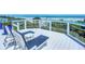 Relaxing deck overlooking the ocean with lounge chairs and side tables at 2903 Hill St, New Smyrna Beach, FL 32169