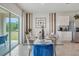 Dining area with glass top table and view into kitchen at 7163 Painted Bunting Way, St Cloud, FL 34773
