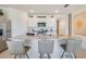 White kitchen cabinets, granite countertops and kitchen island with seating at 7163 Painted Bunting Way, St Cloud, FL 34773
