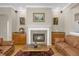 Living room with fireplace and built-in cabinetry, open to kitchen at 10946 Piping Rock Cir, Orlando, FL 32817