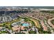 Aerial view of a community with resort-style pools and numerous homes at 1410 Wexford Way, Davenport, FL 33896