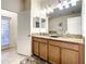 Double vanity bathroom with granite countertop and access to backyard at 1410 Wexford Way, Davenport, FL 33896