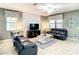 Living room with two leather sofas, a coffee table, and a large TV at 1410 Wexford Way, Davenport, FL 33896