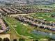 Golf course community with homes and a pond at 1410 Wexford Way, Davenport, FL 33896
