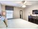 Bedroom with large bed, ceiling fan, and dark dresser at 1410 Wexford Way, Davenport, FL 33896