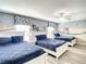 Bedroom with three twin beds and a racing theme mural at 1410 Wexford Way, Davenport, FL 33896
