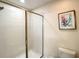 Bright bathroom with a shower and a toilet at 1410 Wexford Way, Davenport, FL 33896