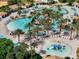 Relaxing pool area with palm trees and a water playground at 1410 Wexford Way, Davenport, FL 33896