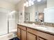 Double vanity bathroom with granite countertops and a shower at 1410 Wexford Way, Davenport, FL 33896