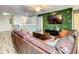 Spacious game room with a large sectional sofa and a large TV at 1410 Wexford Way, Davenport, FL 33896