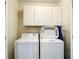 Bright laundry room with washer, dryer, and cabinets at 1410 Wexford Way, Davenport, FL 33896