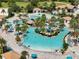 Aerial view of a resort-style pool with a sandy beach area at 1410 Wexford Way, Davenport, FL 33896