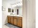 Double vanity bathroom with a large mirror and plenty of cabinet space at 1410 Wexford Way, Davenport, FL 33896
