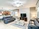 Open concept living room features a kitchen view and comfortable seating at 1410 Wexford Way, Davenport, FL 33896