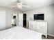 Bedroom with white dresser, large mirror, and a TV at 1410 Wexford Way, Davenport, FL 33896