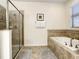 Bathroom with soaking tub, shower and tile flooring at 1410 Wexford Way, Davenport, FL 33896