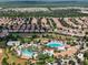 Community pool and clubhouse with surrounding homes and golf course at 1410 Wexford Way, Davenport, FL 33896