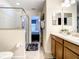 Bathroom with double vanity, walk-in shower, and toilet at 1410 Wexford Way, Davenport, FL 33896