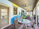 Covered patio with table and chairs, featuring a Mickey Mouse mural at 1410 Wexford Way, Davenport, FL 33896
