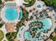 Aerial view of a community with two pools, a lazy river, and a playground at 1410 Wexford Way, Davenport, FL 33896