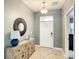 Bright entryway with a wooden console table and a decorative mirror at 1410 Wexford Way, Davenport, FL 33896