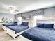Fun themed bedroom with three twin beds, nightstands, and Looney Tunes mural at 1410 Wexford Way, Davenport, FL 33896