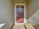 Dark brown front door with sidelights, welcome mat, and small bench at 1410 Wexford Way, Davenport, FL 33896