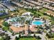 Aerial view of community pool area with multiple pools and a clubhouse at 1410 Wexford Way, Davenport, FL 33896