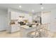Bright kitchen boasts white cabinets, stainless steel appliances, and an island at 1527 Ellesmere Ave, Haines City, FL 33844