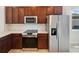 Kitchen features stainless steel appliances and wood cabinets at 3420 Sagebrush St, Harmony, FL 34773