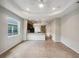 Open living room and kitchen with neutral tile flooring and recessed lighting at 3420 Sagebrush St, Harmony, FL 34773
