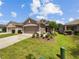 Single-story house with a two-car garage and landscaped front yard at 3420 Sagebrush St, Harmony, FL 34773