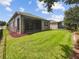 House with a large backyard, screened porch, and fenced-in area at 3420 Sagebrush St, Harmony, FL 34773