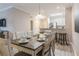 Dining area with a table set for six and a view into the kitchen at 1371 Tuscan Ter # 3204, Davenport, FL 33896