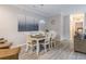 Dining area with a wooden table, white chairs, and view to the living room at 1371 Tuscan Ter # 3204, Davenport, FL 33896