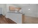 Kitchen with light wood cabinets, white appliances, and a breakfast bar at 17479 Se 82Nd Pecan Ter, The Villages, FL 32162