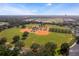 Aerial view of a well-maintained baseball field within a residential community at 17479 Se 82Nd Pecan Ter, The Villages, FL 32162