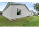 White vinyl-sided home with a small window and landscaping at 17479 Se 82Nd Pecan Ter, The Villages, FL 32162