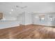 Open concept living room and kitchen with hardwood floors and ceiling fan at 17479 Se 82Nd Pecan Ter, The Villages, FL 32162