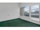 Cozy screened porch with green carpeting and view of backyard at 17479 Se 82Nd Pecan Ter, The Villages, FL 32162