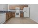 Kitchen boasts light wood cabinets and white appliances at 17479 Se 82Nd Pecan Ter, The Villages, FL 32162