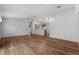 Spacious living room with wood floors and a view into the kitchen at 17479 Se 82Nd Pecan Ter, The Villages, FL 32162