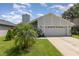 A charming light-blue house with a neat lawn and a two-car garage at 1395 San Luis Ct, Winter Springs, FL 32708