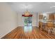 Bright dining room with wood-look floors and access to patio at 17394 Se 74Th Seabrook Ct, The Villages, FL 32162