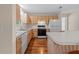 Kitchen with white appliances and light wood cabinets at 17394 Se 74Th Seabrook Ct, The Villages, FL 32162