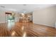 Open living room with wood-look flooring and kitchen views at 17394 Se 74Th Seabrook Ct, The Villages, FL 32162