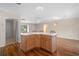 Kitchen island with seating, light wood cabinets and view of entry at 17394 Se 74Th Seabrook Ct, The Villages, FL 32162