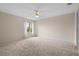 Spacious bedroom with carpeted floor, window with curtains and ceiling fan at 17394 Se 74Th Seabrook Ct, The Villages, FL 32162