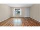 Living room with wood-look floors and window at 17394 Se 74Th Seabrook Ct, The Villages, FL 32162