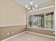 Bright dining room with a chandelier and pool view at 143 Brunswick Dr, Davenport, FL 33837